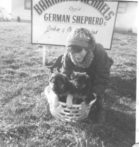 An old photo of me and a basket of puppies.